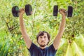 Bicep curl - weight training fitness man outside working out arms lifting dumbbells doing biceps curls. Male sports Royalty Free Stock Photo