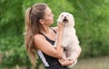 Bichon bolognese dog with beautiful in the park