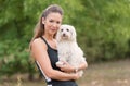 Bichon bolognese dog with beautiful woman in the park