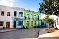 Bici or bike taxi`s waiting in front of colorful colonial house in Camaguey.