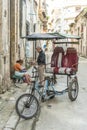 Bicitaxi driver buying morning coffee Havana