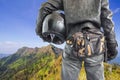 Bicker holding his crash helmet look mountain Royalty Free Stock Photo