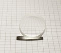 Biconcave optical glass lens on the square background