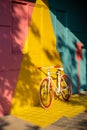 Bicycle against a vibrant wall outdoors