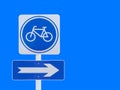 Bicycle with arrow board sign with clipping path isolated on blue background Royalty Free Stock Photo