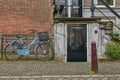 Bicycle as popular way of transport in Amsterdam Netherlands parked and locked in front of traditional house in Holland