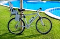 Bicycle with baby seat in grass pool outdoor