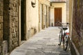 A bicycle with a basket on a narrow European street. Stone houses. Royalty Free Stock Photo