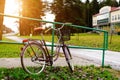 Bicycle with basket parked near urban railings Royalty Free Stock Photo