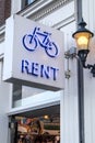 Bicycle bike rent sign with neon lighting and logo outside a rental store