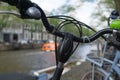 Bicycle black handle bars alongside canal Royalty Free Stock Photo