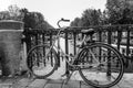 Bicycle on a canal bridge in Amsterdam. Close-up. Black and white Royalty Free Stock Photo