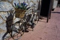 Bicycle carrying flowers parking against the wall