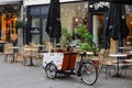 Bicycle with a cart for food delivery. A cozy cafe with delicious coffee and pastries in Eindhoven.