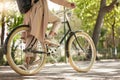 Bicycle, closeup and feet of casual cyclist travel on a bike in a park outdoors in nature for a ride or commuting