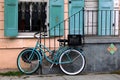 This bicycle is color coordinated with the shutters next to it