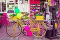 Bicycle with colorful flowers basket next to a tandoori tea restaurant