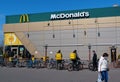 Bicycle couriers wait for orders near McDonalds fast food restaurant Royalty Free Stock Photo