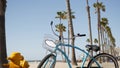 Bicycle cruiser bike by ocean beach, California coast USA. Summer cycle, lifeguard hut and palm tree Royalty Free Stock Photo