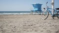 Bicycle cruiser bike by ocean beach California coast USA. Summer sea shore. Cycle by lifeguard tower