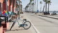 Bicycle cruiser bike by ocean beach, California coast USA. Summertime cycle, cottages and palm tree. Royalty Free Stock Photo