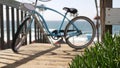 Bicycle cruiser bike by ocean beach, California coast USA. Summertime cycle, stairs and palm trees. Royalty Free Stock Photo