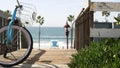 Bicycle cruiser bike by ocean beach, California coast USA. Summertime cycle, stairs and palm trees. Royalty Free Stock Photo
