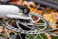 Bicycle disk brake rotor in focus. Metal details of transport concept