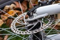 Bicycle disk brake rotor in focus. Metal details of transport concept