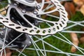 Bicycle disk brakes close up, grey metal disc attached to bike wheel, effective popular mountain bicycle brakes Royalty Free Stock Photo