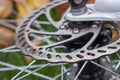 Bicycle disk brakes close up, grey metal disc attached to bike wheel, effective popular mountain bicycle brakes Royalty Free Stock Photo