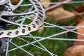 Bicycle disk brakes close up, grey metal disc attached to bike wheel, effective popular mountain bicycle brakes Royalty Free Stock Photo