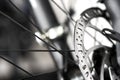 Bicycle disk brakes close up, metal disc attached to bike wheel, effective mountain bicycle brakes Royalty Free Stock Photo