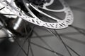 Bicycle disk brakes close up, metal disc attached to bike wheel, effective mountain bicycle brakes Royalty Free Stock Photo