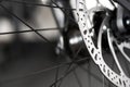 Bicycle disk brakes close up, metal disc attached to bike wheel, effective mountain bicycle brakes Royalty Free Stock Photo