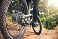 Bicycle, forest and wheels on a dirt road trail for fitness, adventure workout and exercise. Closeup of a sports bike