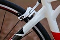 bicycle frame detail with rear brake caliper, rear wheel, spokes and tire (close up of white painted bicycle frame) Royalty Free Stock Photo