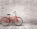 Bicycle in front of a grey brick wall.