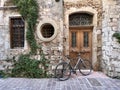 Bicycle in front of a historic stone building in Greece, Europe.