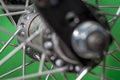 bicycle front wheel hub with spokes fitting detail on green background. Royalty Free Stock Photo