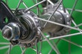 bicycle front wheel hub with spokes fitting detail on green background. Royalty Free Stock Photo