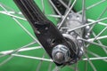 bicycle front wheel hub with spokes fitting detail on green background. Royalty Free Stock Photo