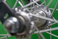 bicycle front wheel hub with spokes fitting detail on green background. Royalty Free Stock Photo