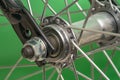 bicycle front wheel hub with spokes fitting detail on green background. Royalty Free Stock Photo