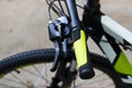 Bicycle handlebar with green grips on street background