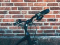 Bicycle handlebar leaning on to brick wall in Halmstad, Sweden Royalty Free Stock Photo