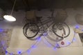 Bicycle hanging on the wall with Christmas lights Royalty Free Stock Photo