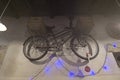 Bicycle hanging on the wall with Christmas lights and chandeliers Royalty Free Stock Photo