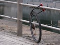 Bicycle stolen, leaving only a wheel, still locked to metal railing. Royalty Free Stock Photo