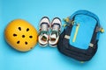 Bicycle helmet, sneakers and backpack on light blue background, flat lay Royalty Free Stock Photo